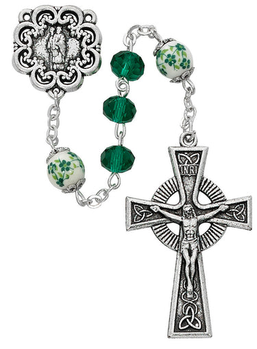 Green crystal St. Patrick rosary with silver oxidized crucifix and center piece on white background
