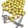 Yellow children's Catholic rosary for girls with 5mm yellow beads decorated with silver stars, chain-link construction, in gift box