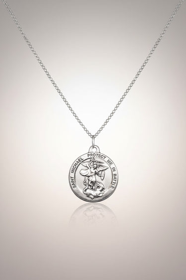 Sterling silver St. Michael the Archangel medal necklace with 18" chain. Features detailed relief of St. Michael protecting.
