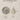 Saint Dymphna Gold Filled medal with size comparison to a U.S. quarter on a beige background