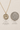 Gold Filled Saint Dymphna medal necklace with size and quarter coin comparison on a beige background