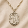 A gold-filled Saint Michael medal pendant necklace on a textured chain, displayed on a beige fabric background with the text '14 KT GOLD FILLED' at the bottom.