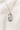 Sterling Silver pendant necklace with 'Saint Dymphna' on a beige fabric background