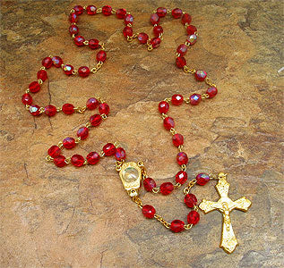 Red glass Catholic rosary with Holy Sand center medallion, golden tone chain and crucifix, 19 inch length, made in Italy