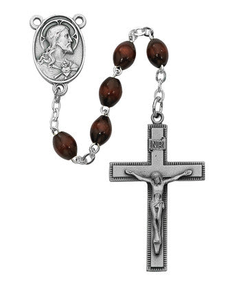 Close-up of 4x6mm oval brown wood rosary beads with pewter crucifix detail