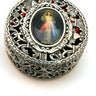 Large metal filigree rosary box with full-color Divine Mercy medal on lid, ornate floral design, 2.75 inch diameter with velvet interior