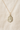 Gold Filled St Dymphna medal necklace with a religious pendant on a beige fabric background
