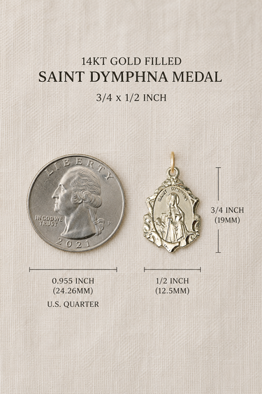 Saint Dymphna Gold Filled medal with size comparison to a U.S. quarter on a beige background