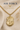 A gold Air Force pendant necklace displayed on a beige fabric background with decorative dried flowers. The image includes text reading 'AIR FORCE' and '14 KT GOLD FILLED' with a winged emblem above.