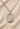 A gold-filled Saint Michael medal pendant necklace on a textured chain, displayed on a beige fabric background with the text '14 KT GOLD FILLED' at the bottom.